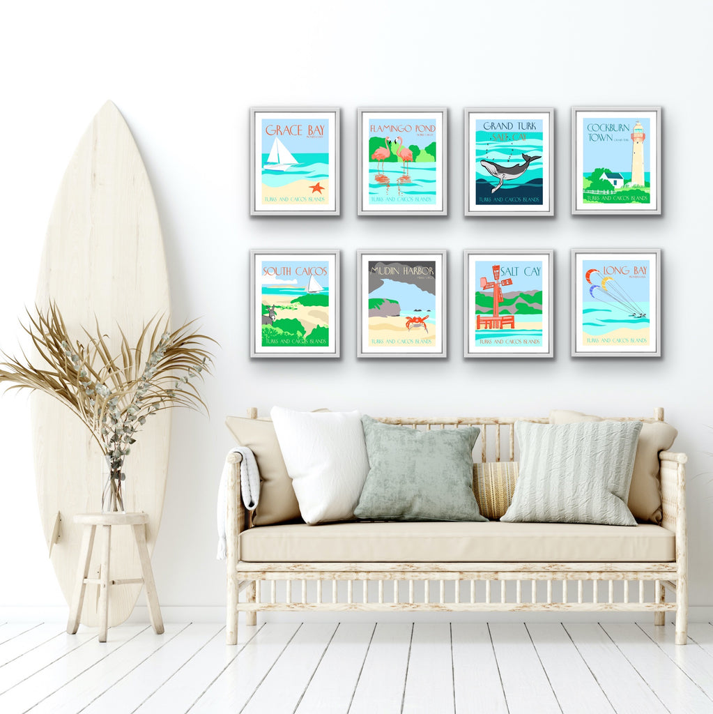 White living room with surfboard and 8 framed graphic travel art prints from the turks and caicos islands